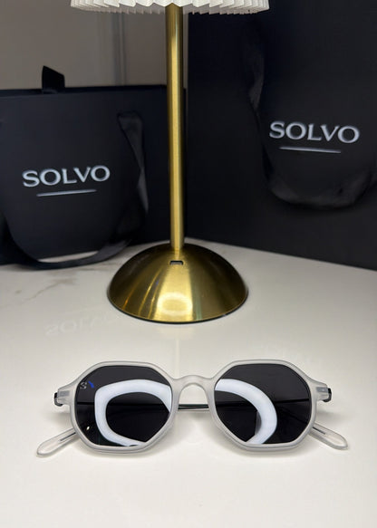 Sunglasses with a unique design on a white surface with Solvo branding in the background.